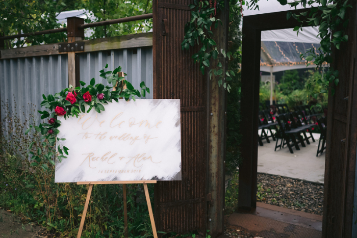 Wedding Welcome Sign with Red Florals and Greenery