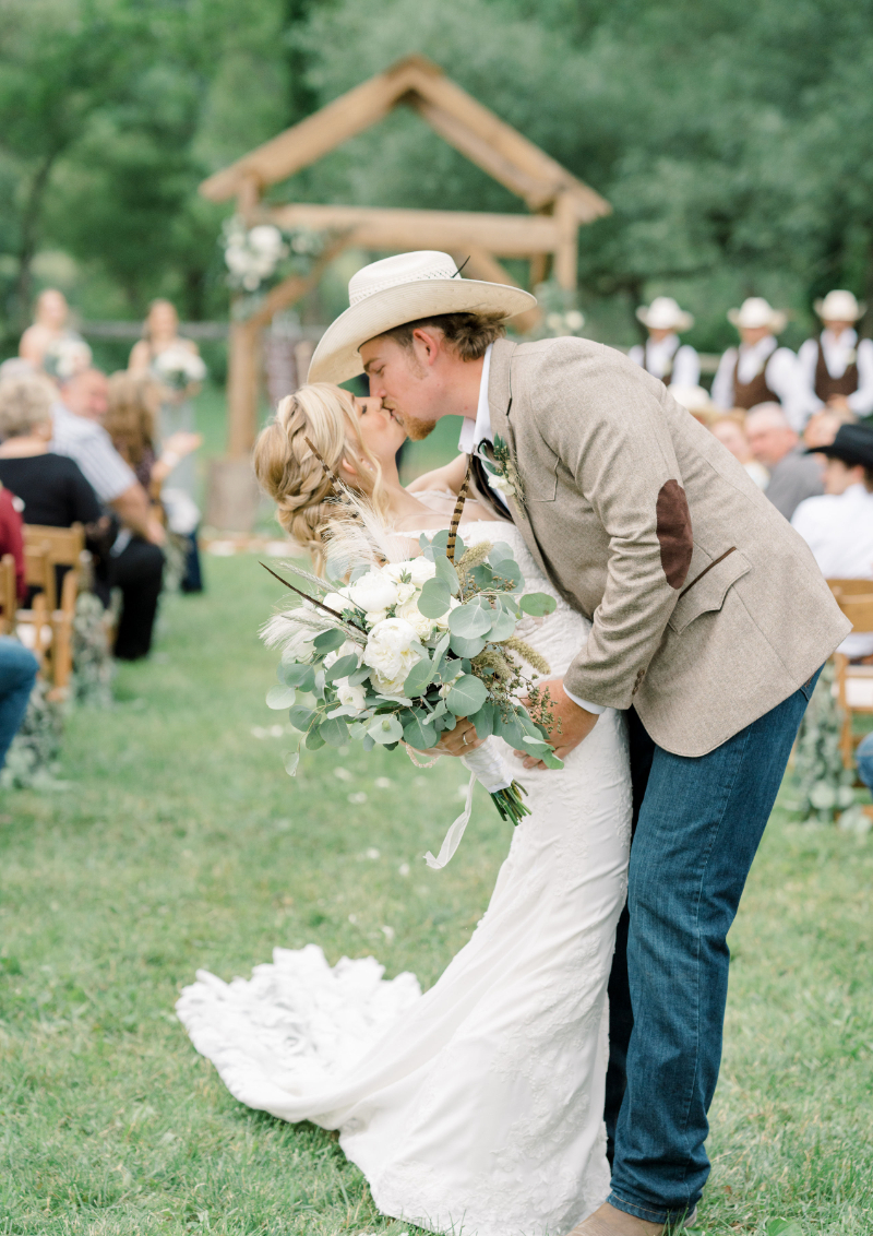 bride and groom kiss after the wedding ceremony