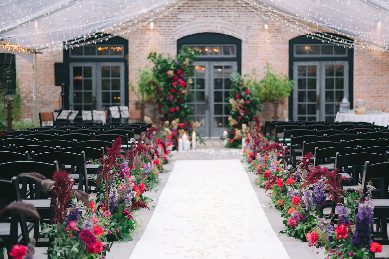 Colorful pink purple and red floral wedding ceremony