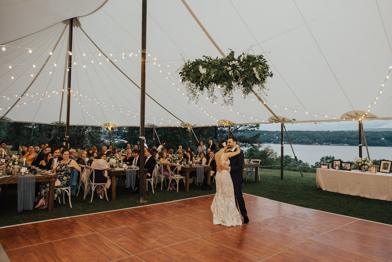 outdoor tented wedding with greenery chandelier over the dance floor