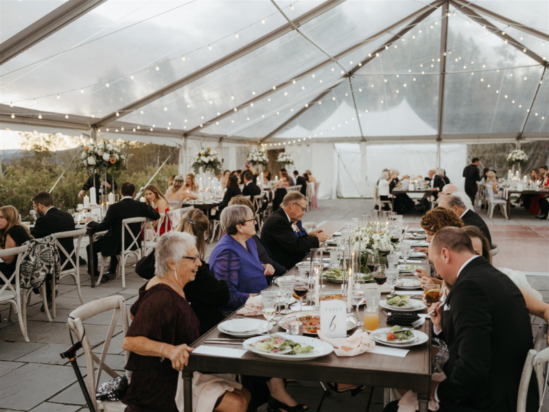outdoor tented wedding reception with family style catering