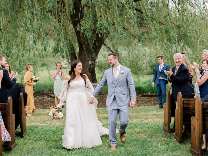 bride and groom walk down aisle at Nostrano Vineyards