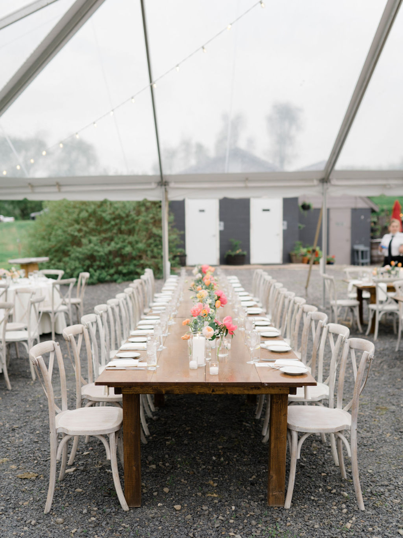 spring wedding floral centerpieces underneath clear top tent