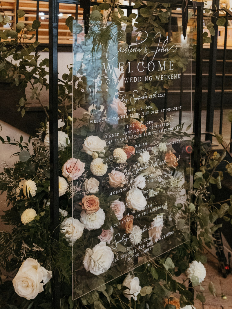 floral arrangements on wedding welcome sign