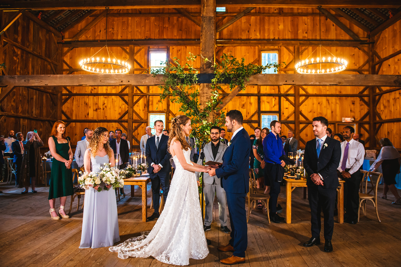 bride and groom stand with just a MOH and BM