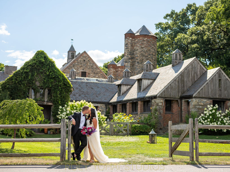 bride and groom kiss outside wedding at Blue Hill