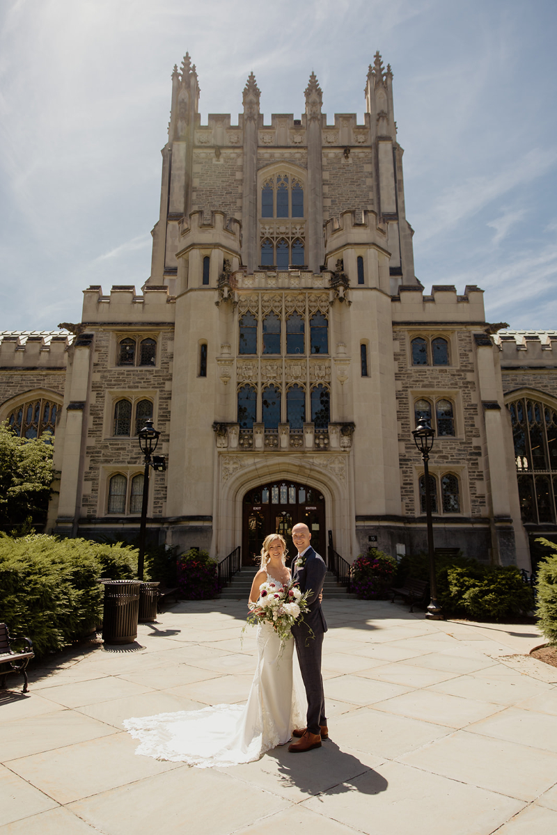 bride and groom stand outside garden wedding venue