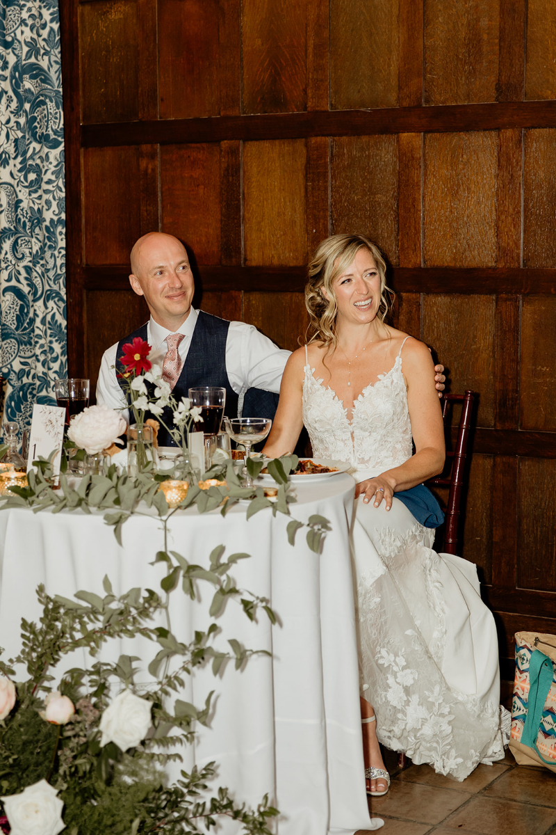 bride and groom sit at sweetheart table at wedding at Vassar College