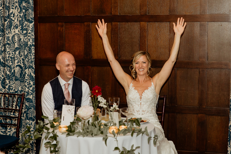 bride and groom sit at sweetheart table at wedding at Vassar College