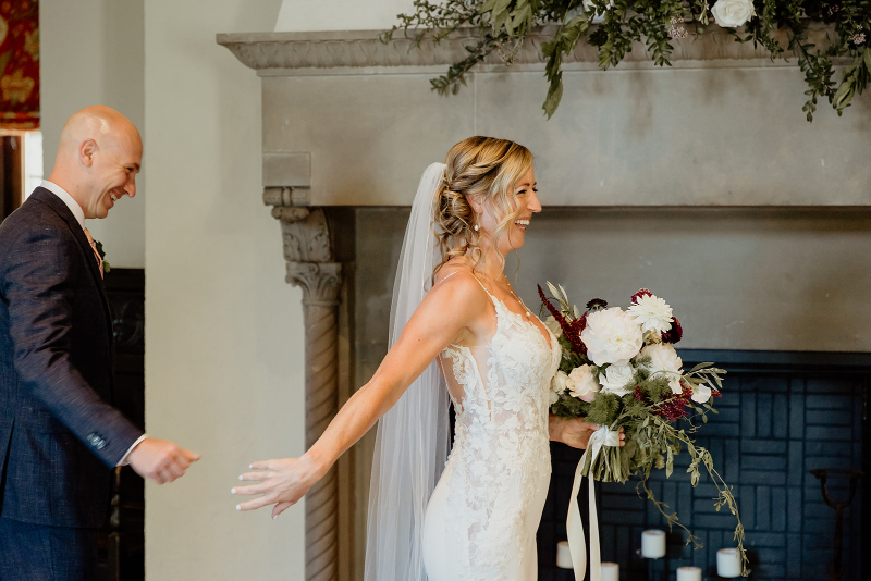 groom stares at bride during first look