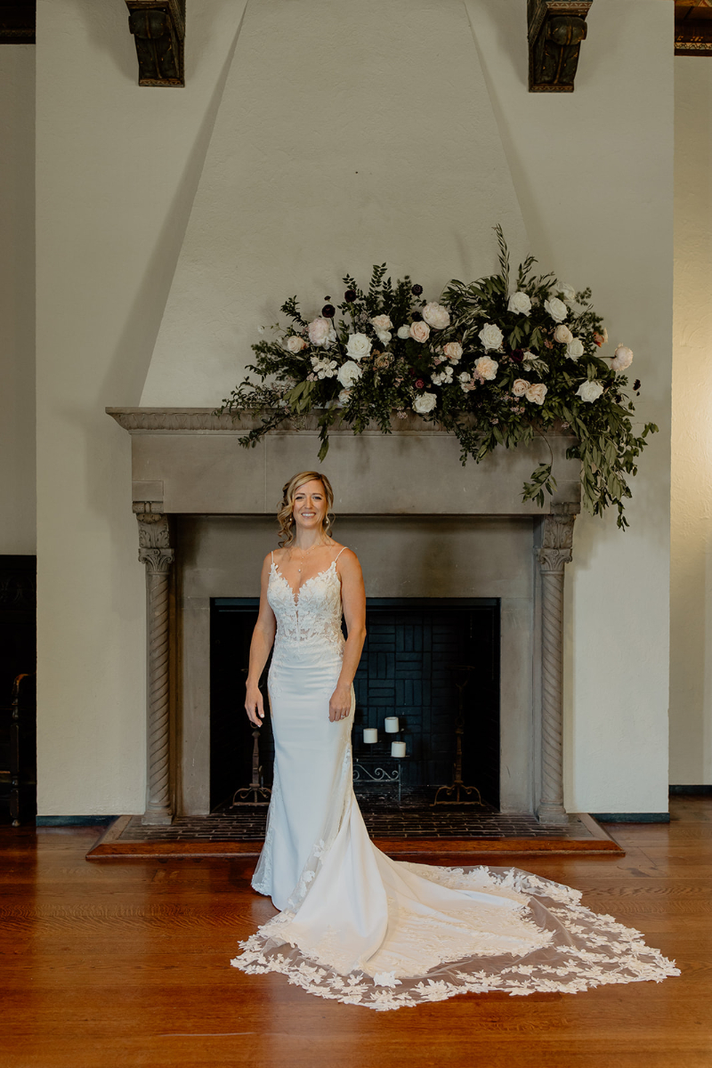 bride stands in front of fireplace at Vassar College