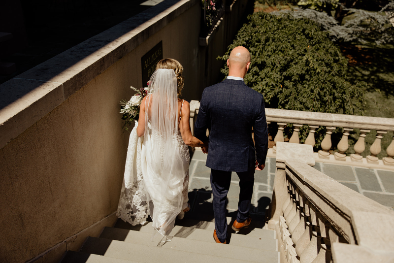 bride and groom walk down the stairs