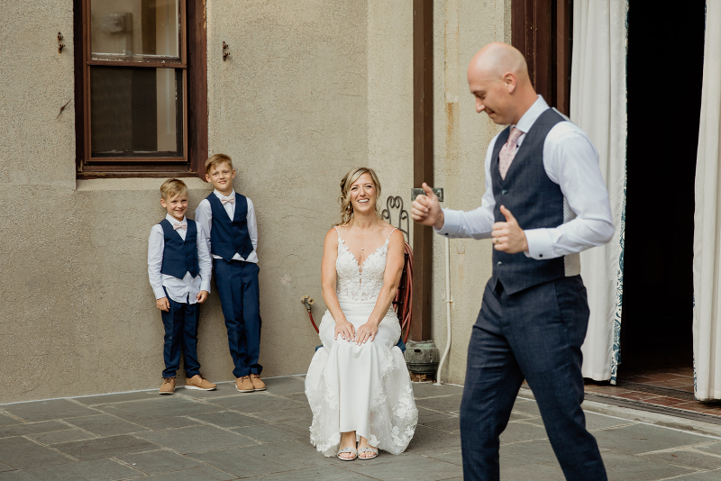 groom performs song and dance for bride during wedding at Vassar College