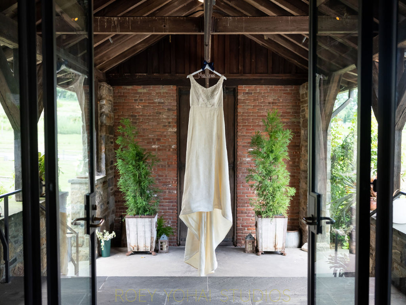 brides dress hanging before wedding at Blue Hill at Stone Barns
