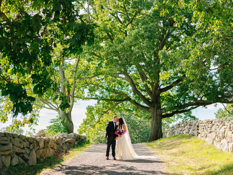 bride and groom pose for wedding photos at Blue Hill Farms
