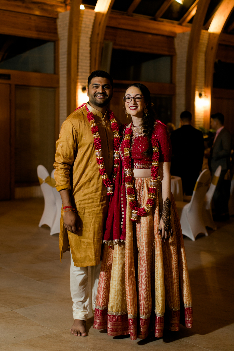 bride and groom pose at Mendhi wedding