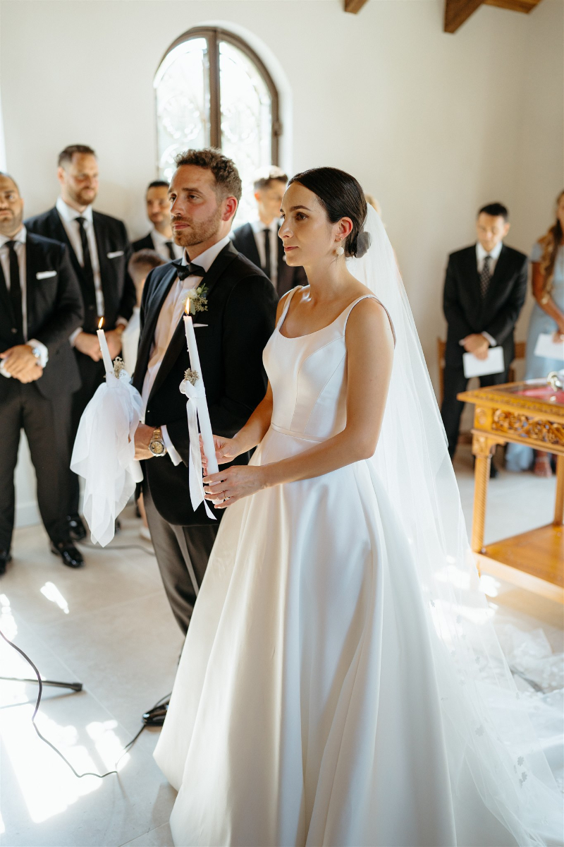 bride and groom stand at altar