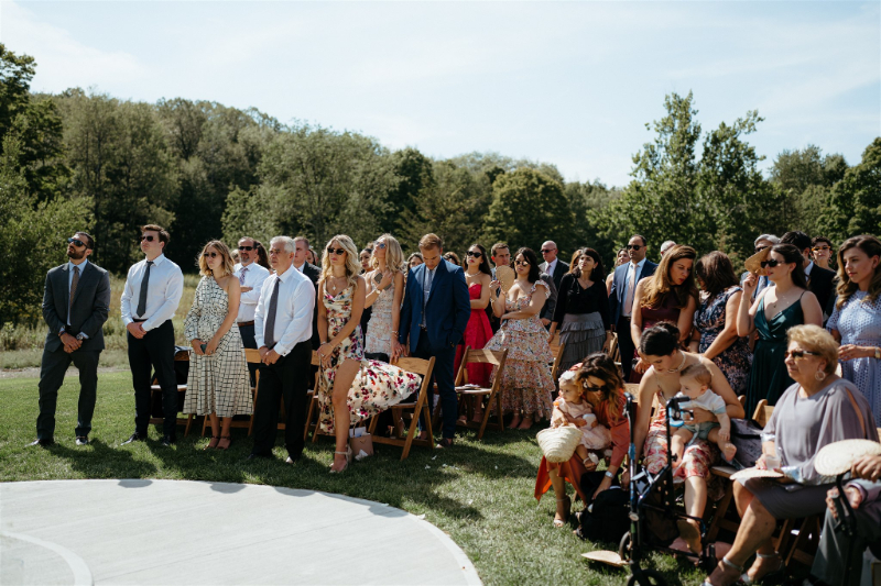 wedding guests sit outside church