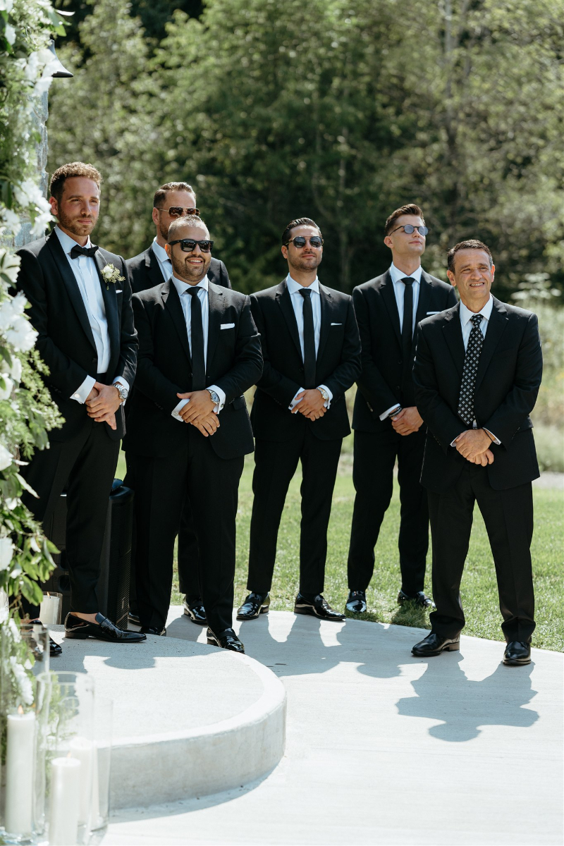 groom and groomsmen wait outside church