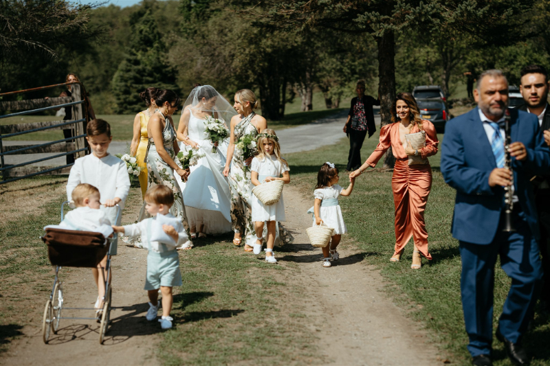 bride walks to ceremony for outdoor wedding at home in Upstate NY