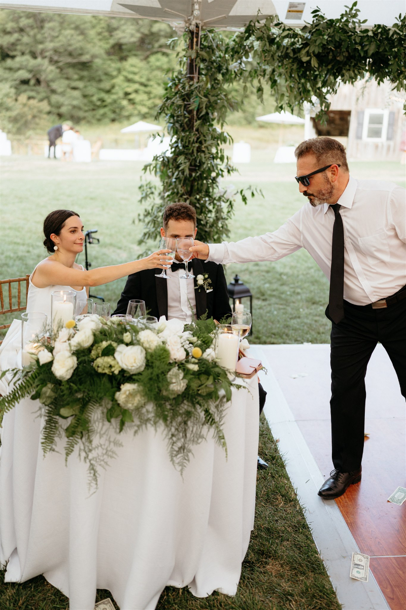 bride and groom sit at sweetheart table