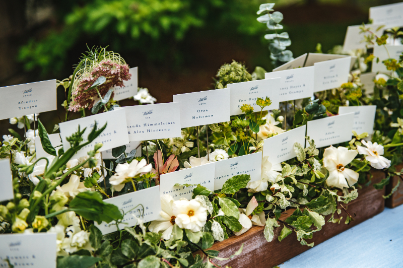 white and greenery escort display flowers