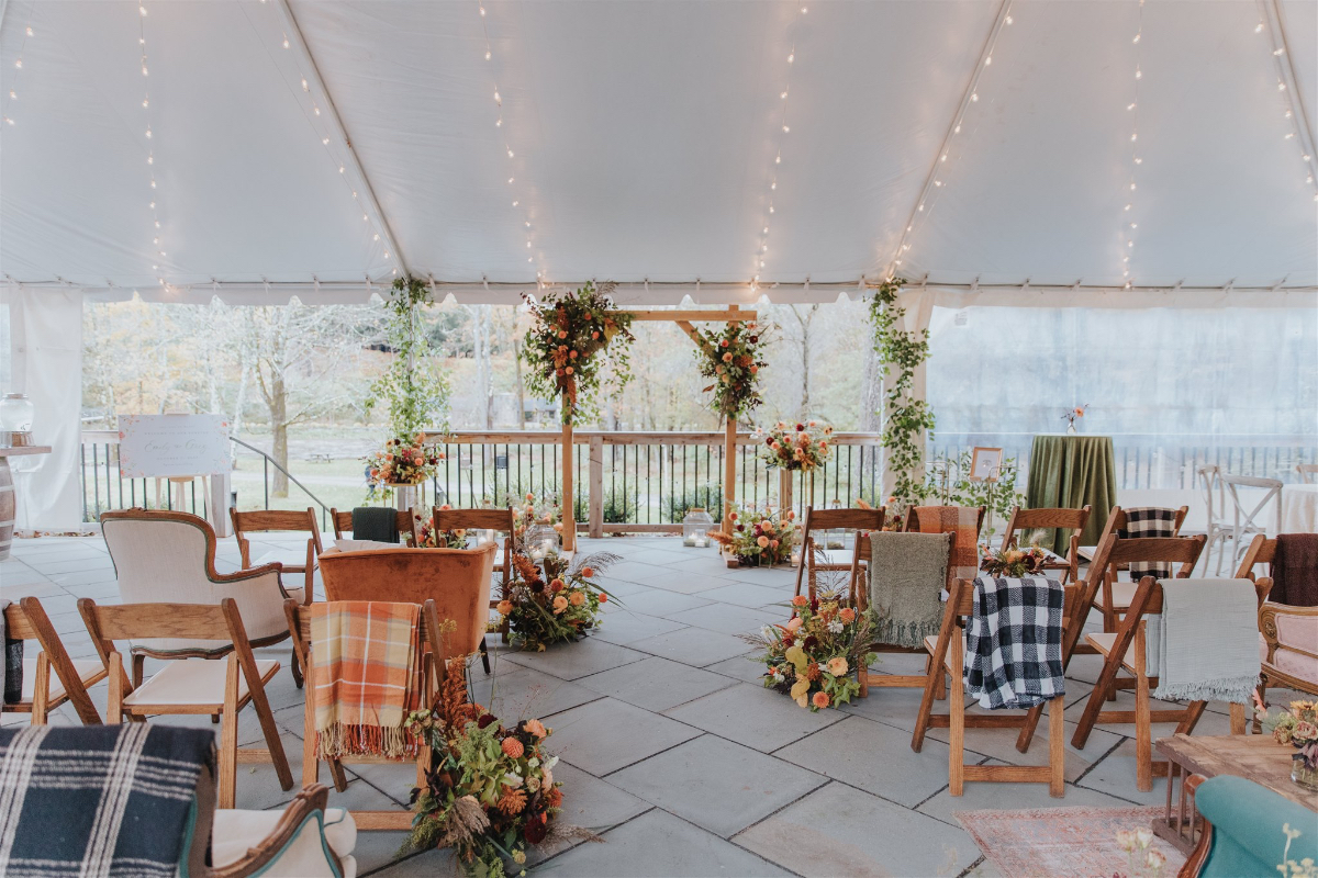 Rustic outdoor ceremony space surrounded by vibrant fall foliage at Antrim Streamside.