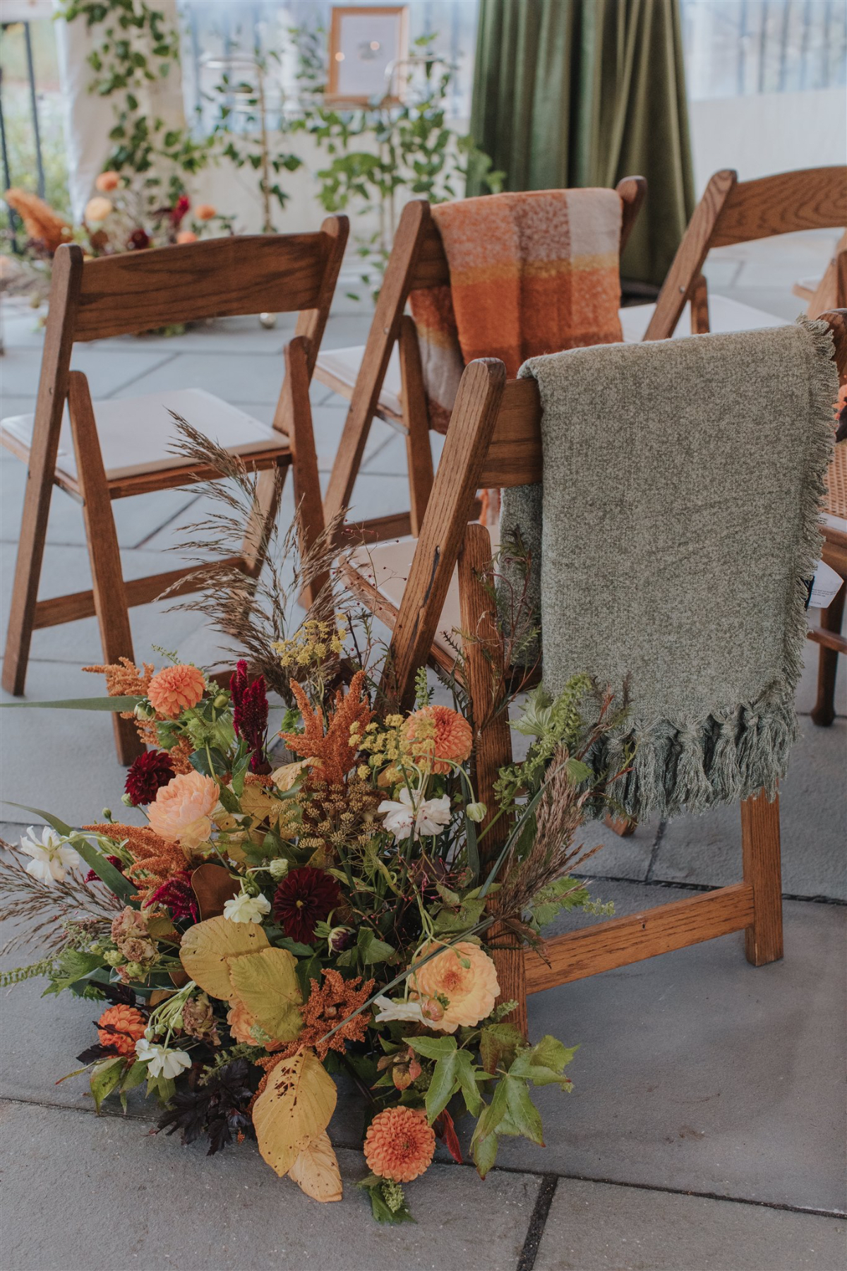 Cozy blankets placed for guests to stay warm, adding a thoughtful touch to the fall wedding.