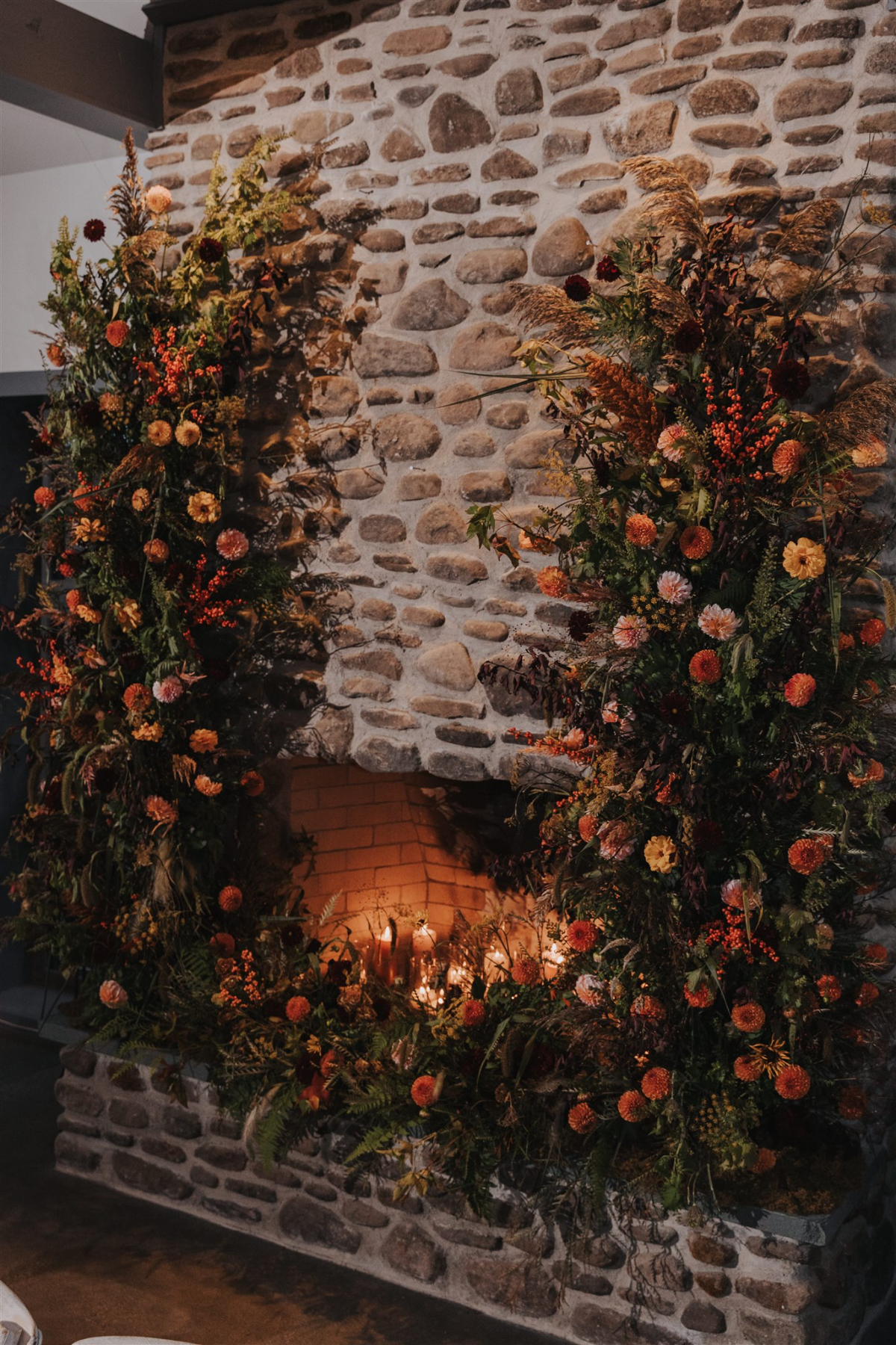 Beautiful floral arrangements adorning the fireplace in the reception hall