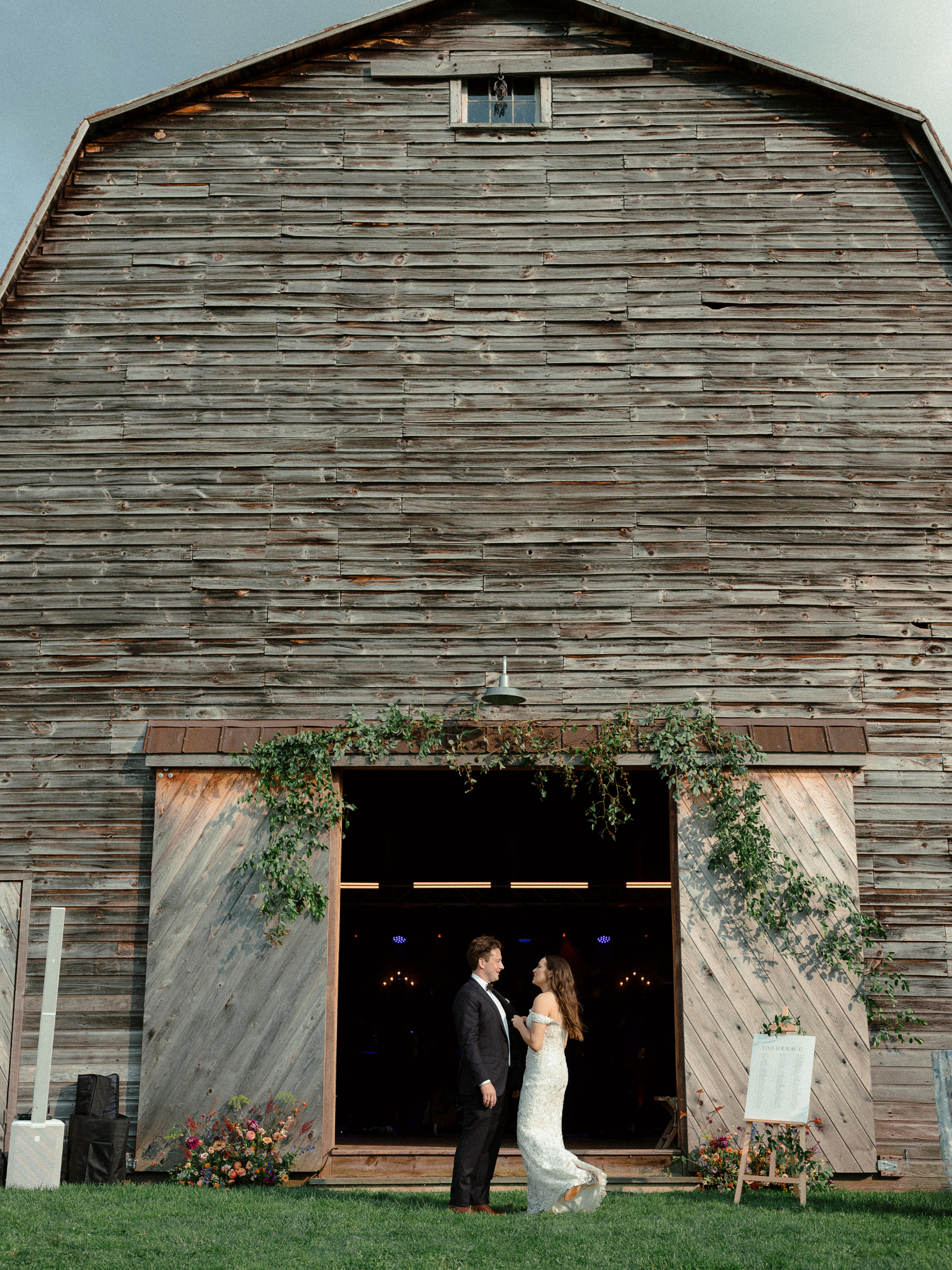 bride and groom outside of barn wedding reception