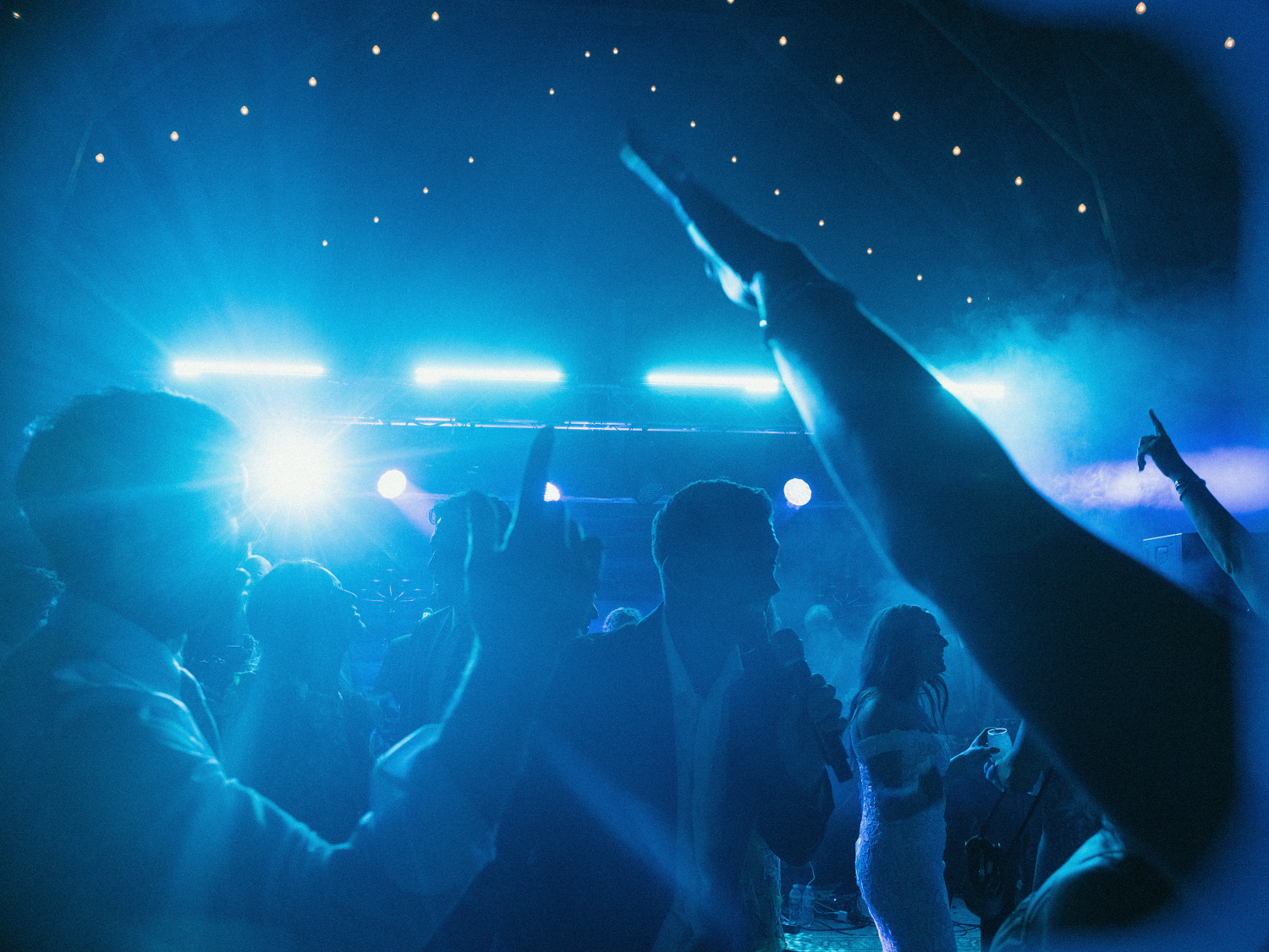dance floor moment with moody blue lighting and a lively crowd