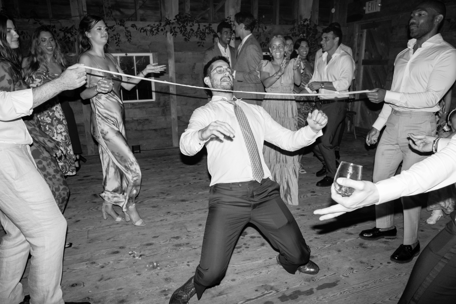black and white dance floor moment with a guest doing the limbo
