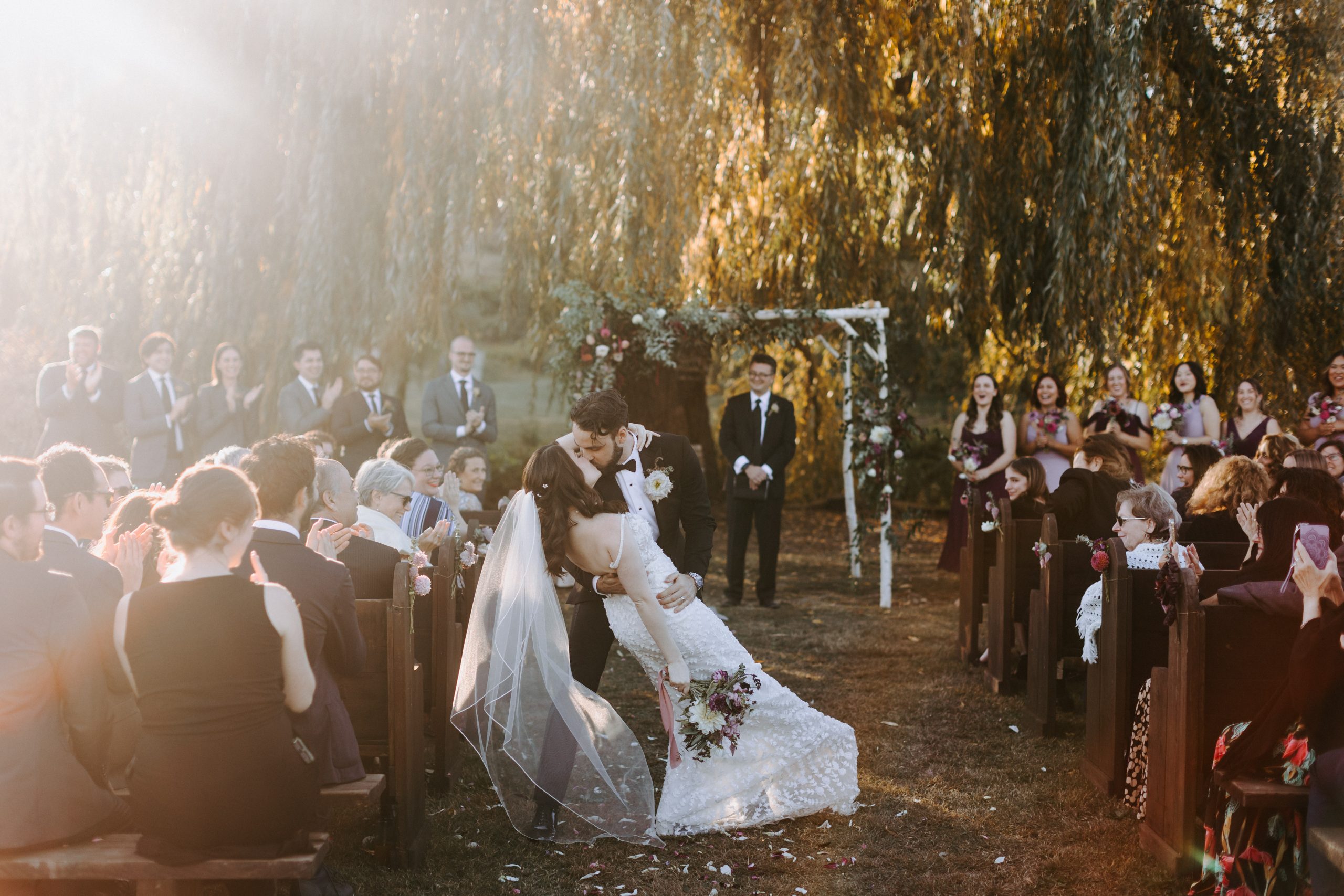 bride and groom kiss at the end of the aisle at Hudson valley wedding