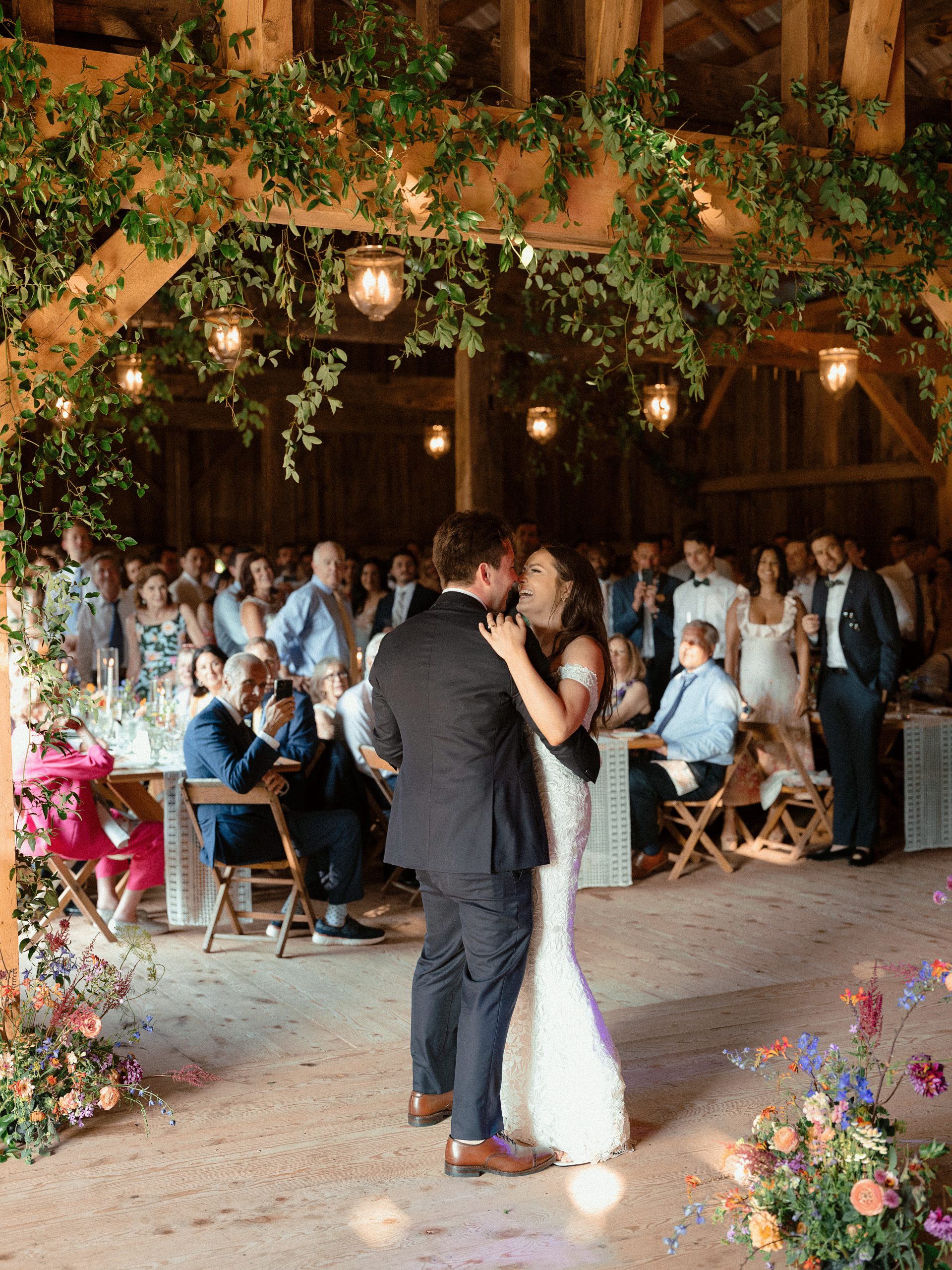 greenery overhead as couple dances