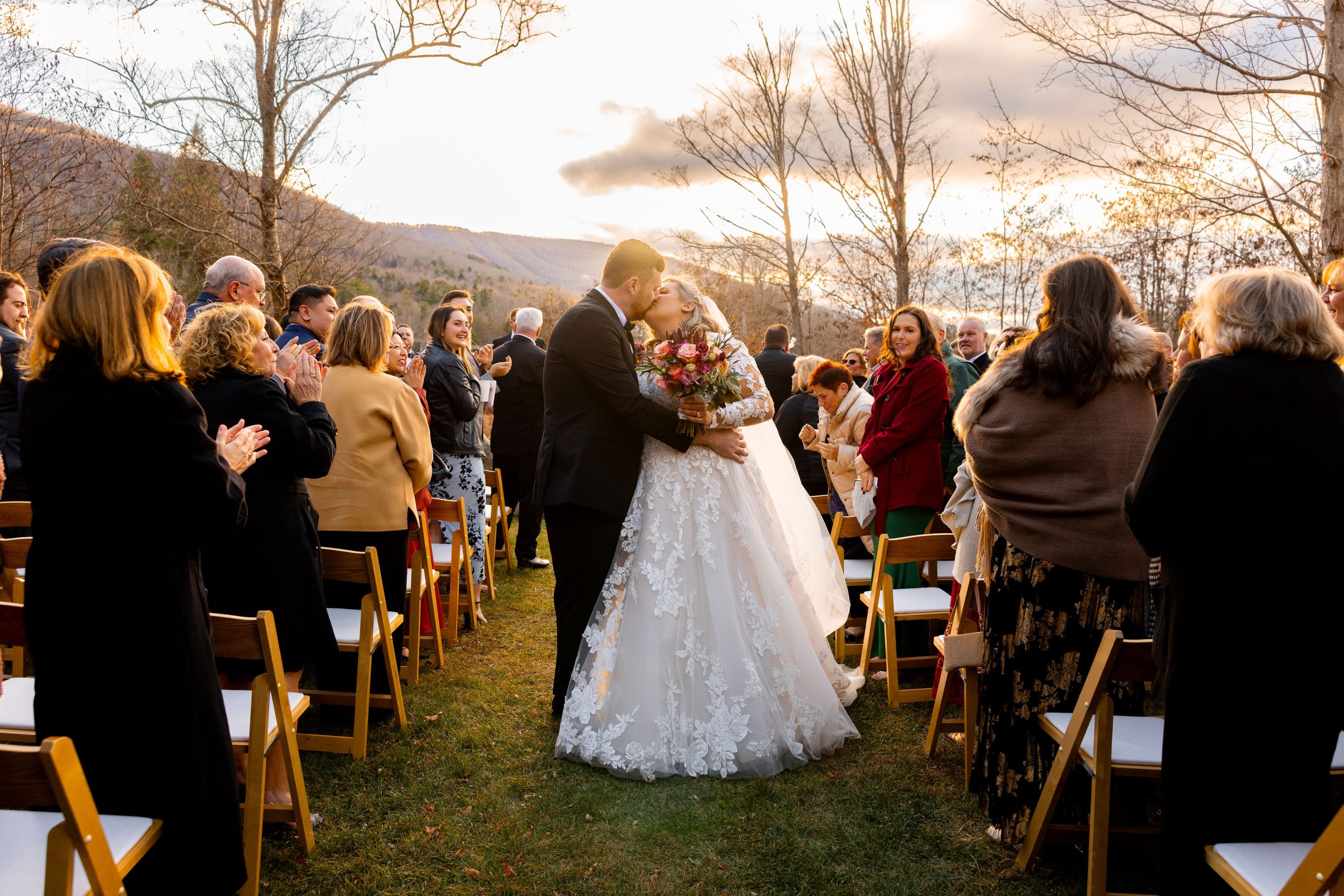 bride and groom kissing at the end of the aisle -the best wedding media opportunity 
