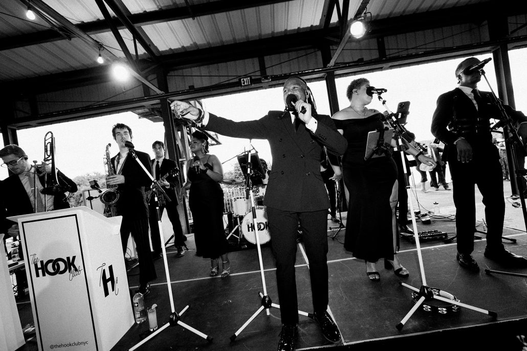 Wedding DJ's in Hudson Valley with live band hybrid on stage, multiple vocalists and horns performing for a high energy reception.