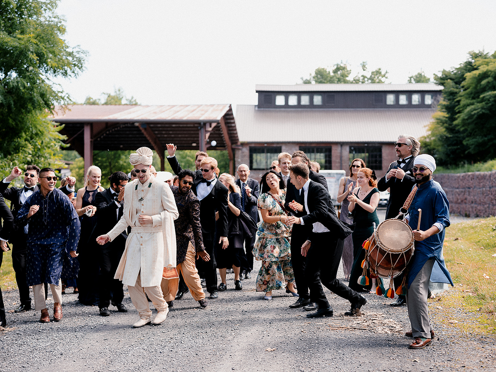 Groom dancing with friends and family during his lively baraat procession at Hutton Brickyards.