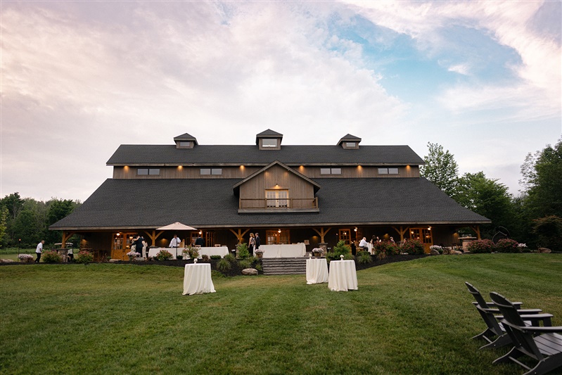 Evening view of a grand barn venue surrounded by manicured lawns, ideal for weekend weddings in the Hudson Valley.