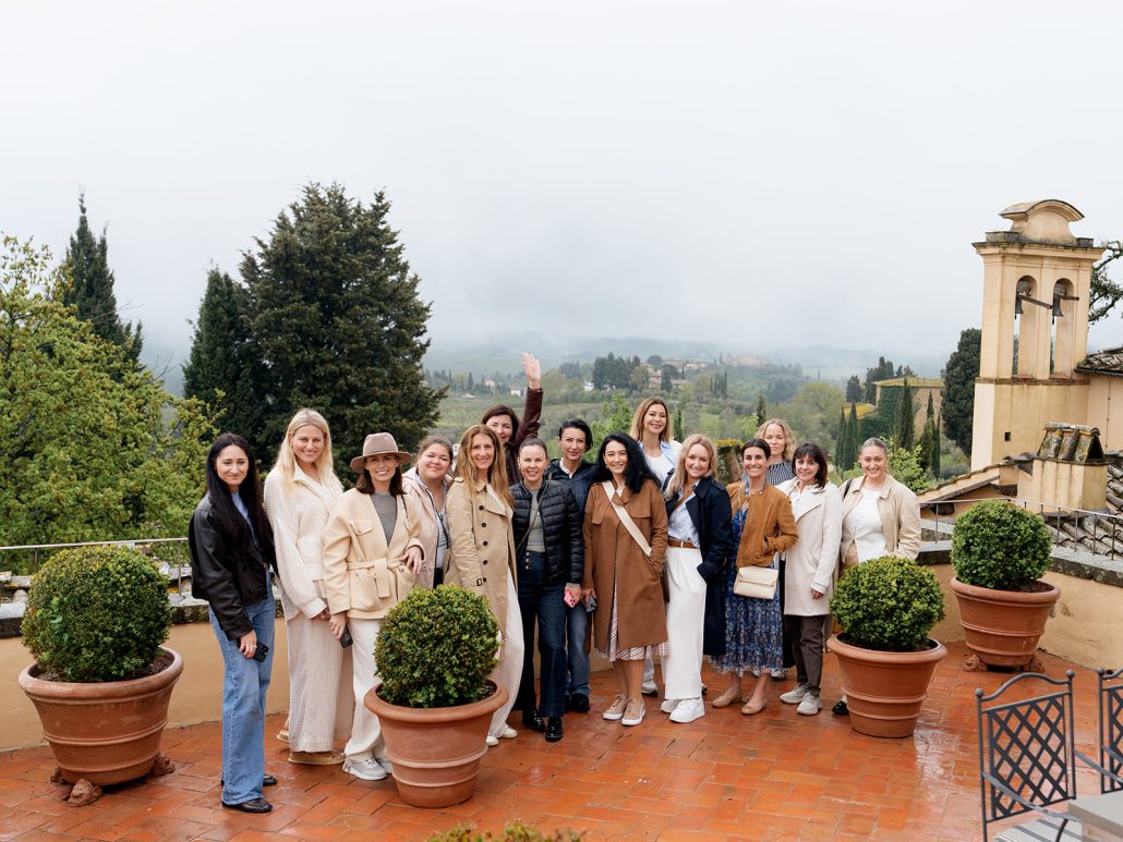 Group of wedding planners on a terrace at COMO Castello Del Nero with Tuscan countryside views, a top luxury wedding venue in Tuscany.