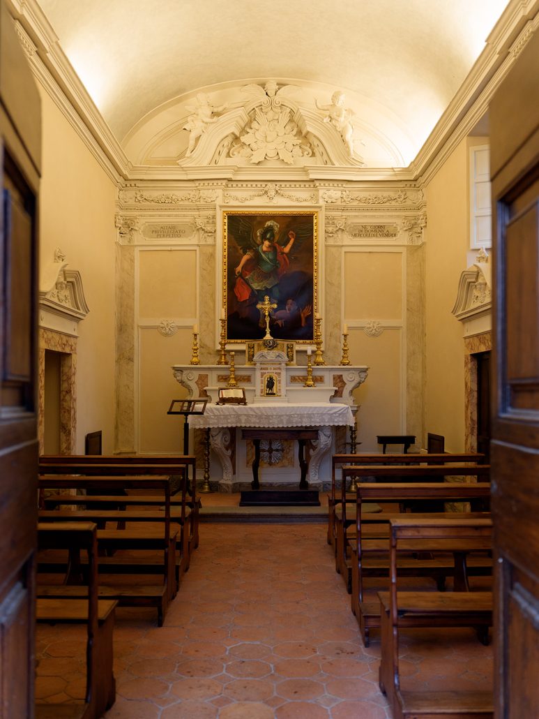 Intimate consecrated chapel inside COMO Castello Del Nero, an Italian wedding venue offering historic ceremony spaces in Tuscany.