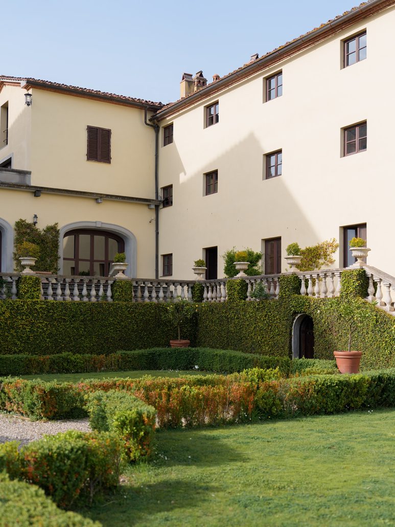 Exterior of Viesca Toscano villa in Tuscany with manicured gardens, ivy-covered walls, and classic architecture, an ideal wedding ceremony backdrop.