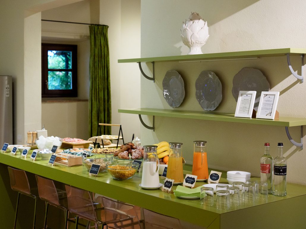 Breakfast buffet with pastries, fruit, juices, and charcuterie at Villa Medicea di Lilliano, a luxury Italian wedding venue in Tuscany.
