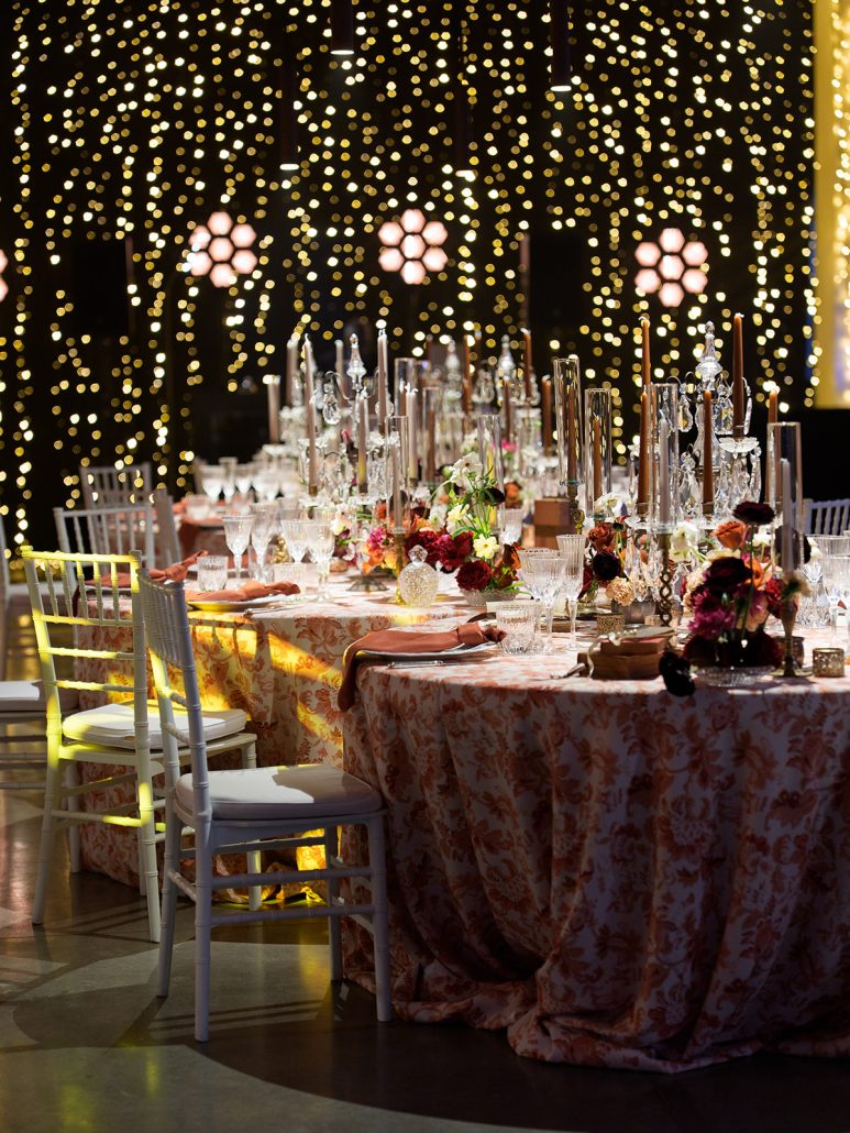 Luxury wedding dinner at Villa Medicea di Lilliano featuring candlelit tables, lush flowers, and twinkling lights for a Tuscany wedding.
