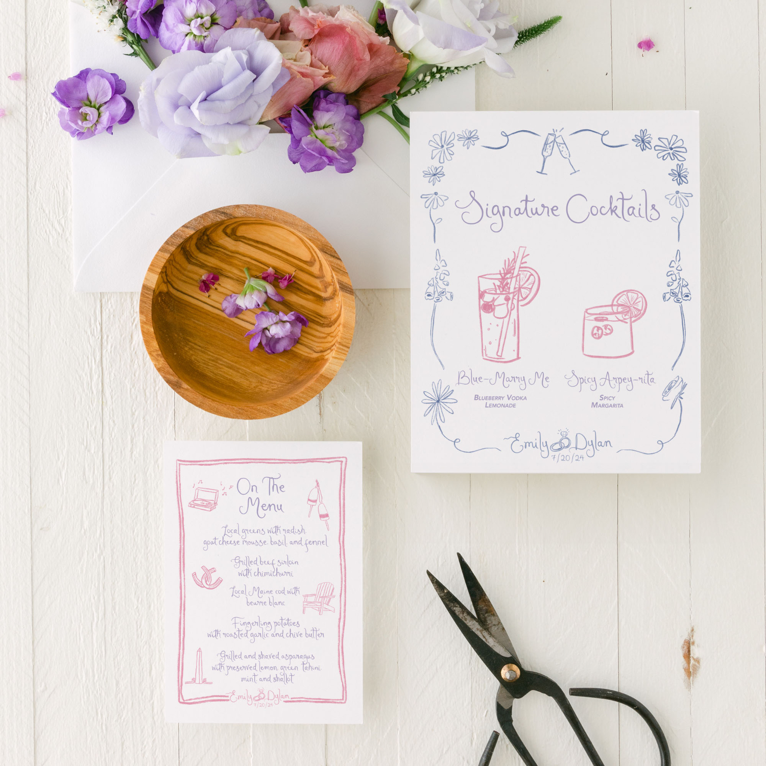 Hand-illustrated wedding cocktail and menu cards, styled with wood accents, fresh blooms, and modern calligraphy.