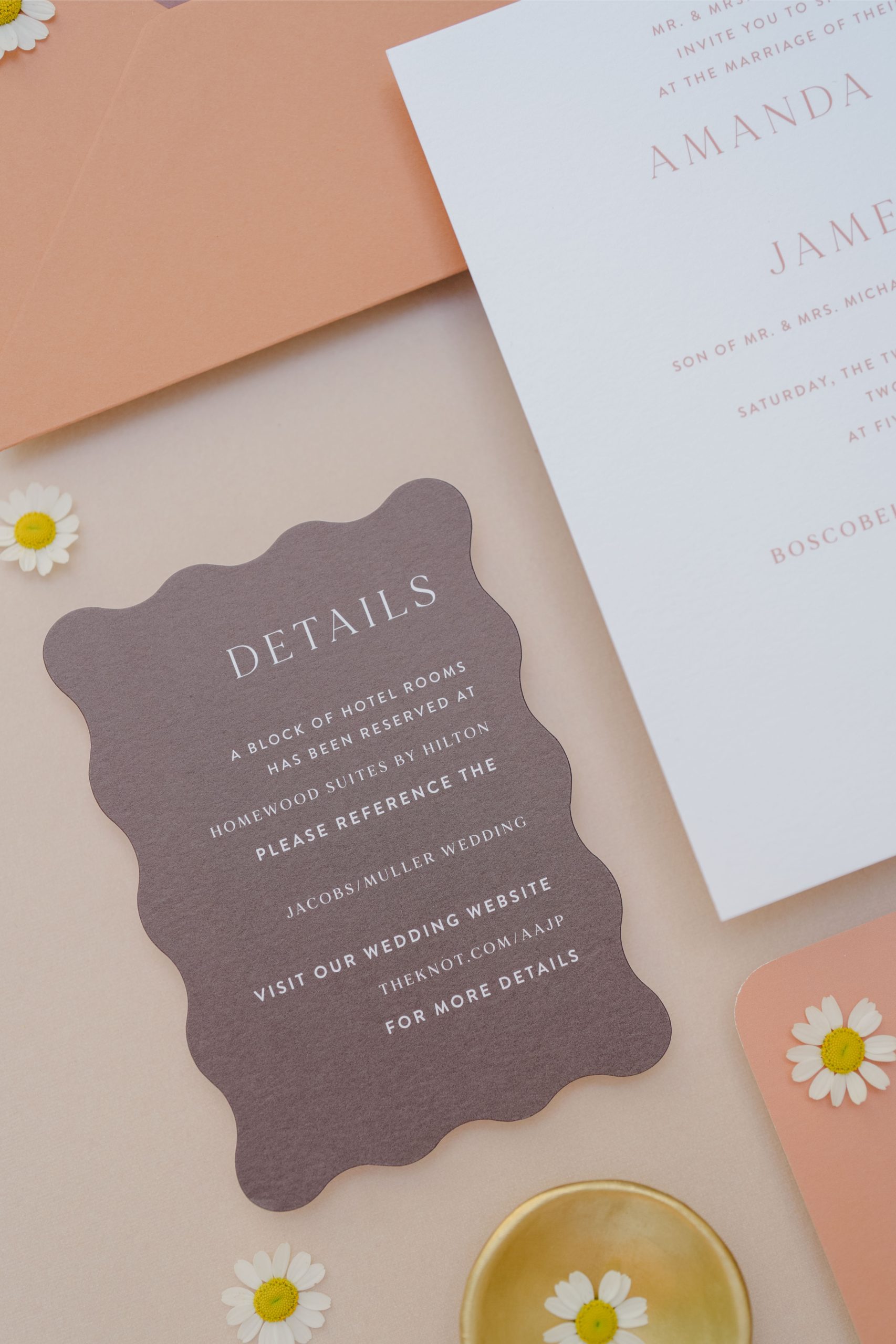 Close-up of a wedding “Details” card featuring hotel info and RSVP instructions—part of a mailed invitation suite.