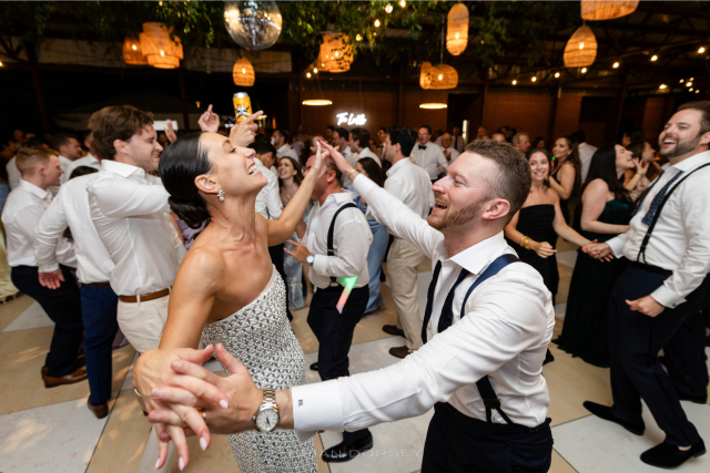 bride and groom share a energetic dance on the dance floor.