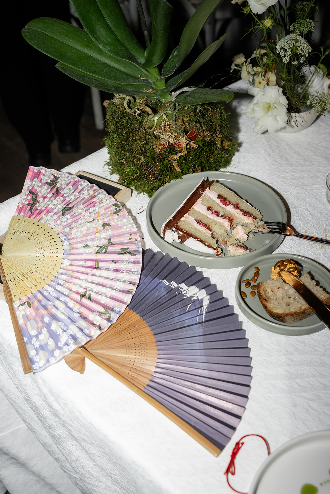 Close-up of wedding cake slices and sweet takeaway desserts for guests.