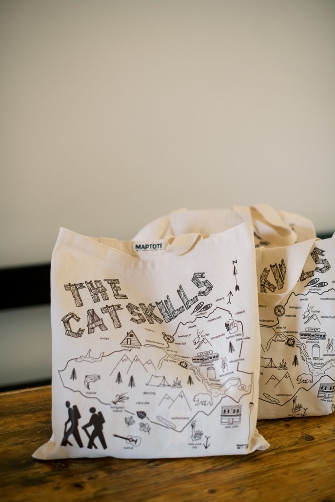 Illustrated tote bags featuring a map of the region set out as welcome gifts for wedding guests.