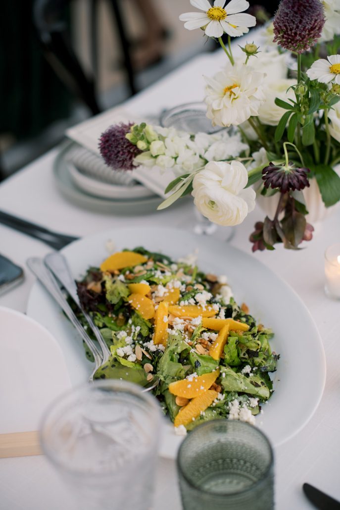 Fresh green salad with citrus, nuts, and cheese served at the wedding dinner.