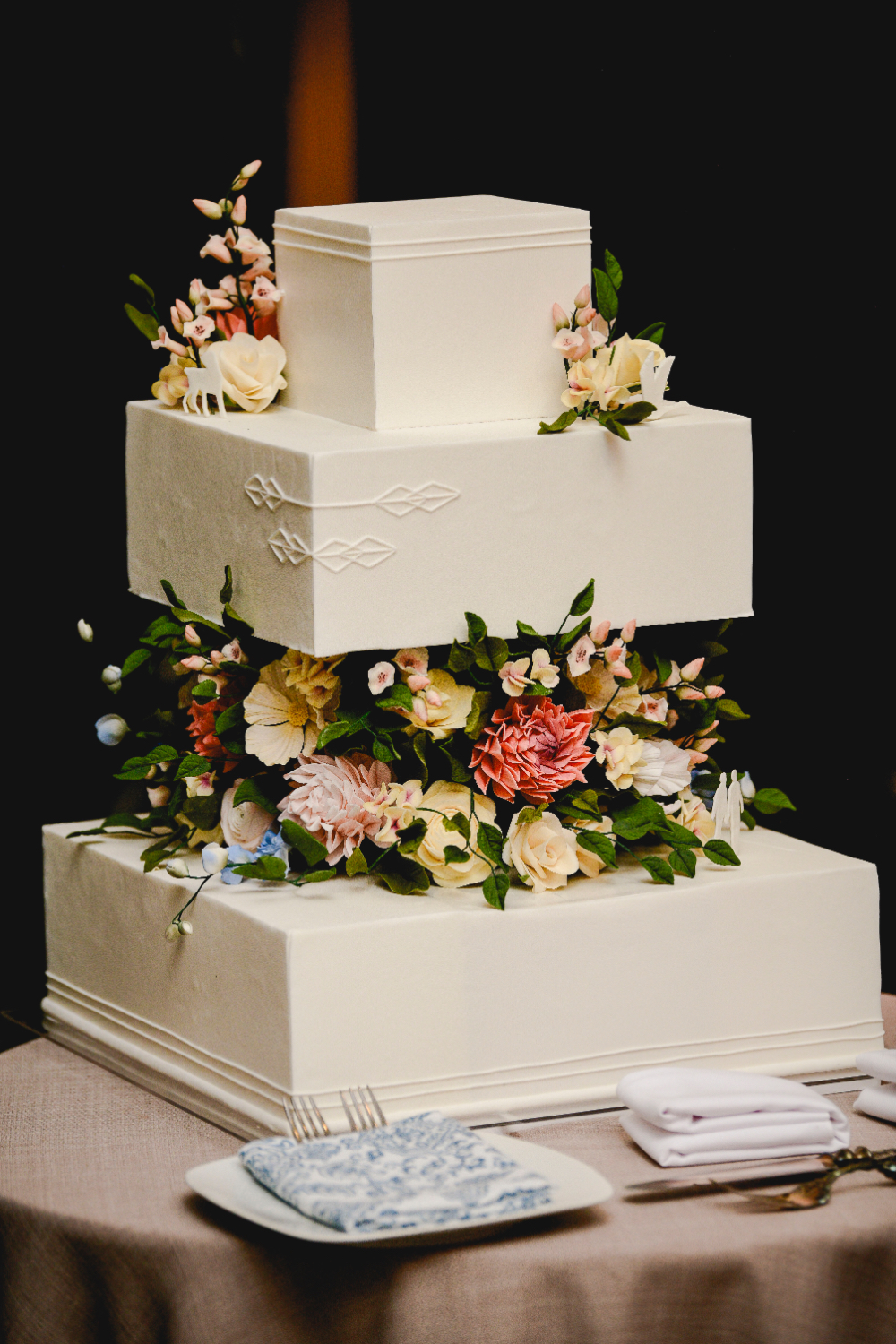 A detailed shot of the wedding cake featuring personalized touches.